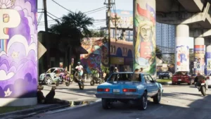 Zila klasiskā automašīna brauc pa Vice City ielu zem pārvada ar krāsainiem grafiti zīmējumiem spēles GTA 6 kadrā