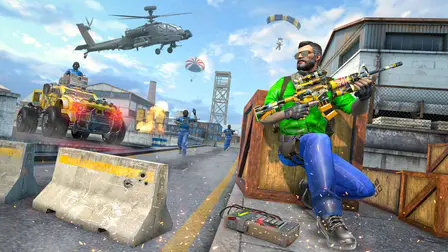 FPS Gun Shooting Game 3D promotional banner showcasing an action-packed military combat scene. In the foreground, a bearded male soldier wearing sunglasses and a bright green jacket crouches defensively behind a wooden crate, holding a customized yellow and black assault rifle equipped with a large scope. A remote detonator device lies on the ground near his boot. In the background, an armored yellow tactical vehicle drives past concrete jersey barriers with visible bullet holes, while other soldiers sprint across an industrial airfield. A military attack helicopter flies overhead against a blue sky with scattered clouds, and a paratrooper descends in the distance.
