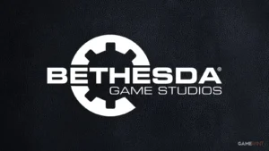 Balts Bethesda Game Studios logotips ar zobrata simbolu uz melnas teksturētas ādas fona