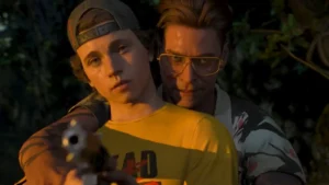 Divi jauni vīrieši, no kuriem viens tēmē ar ieroci, uz meža un lapotnes fona spēles Until Dawn 2 reklāmas attēlā