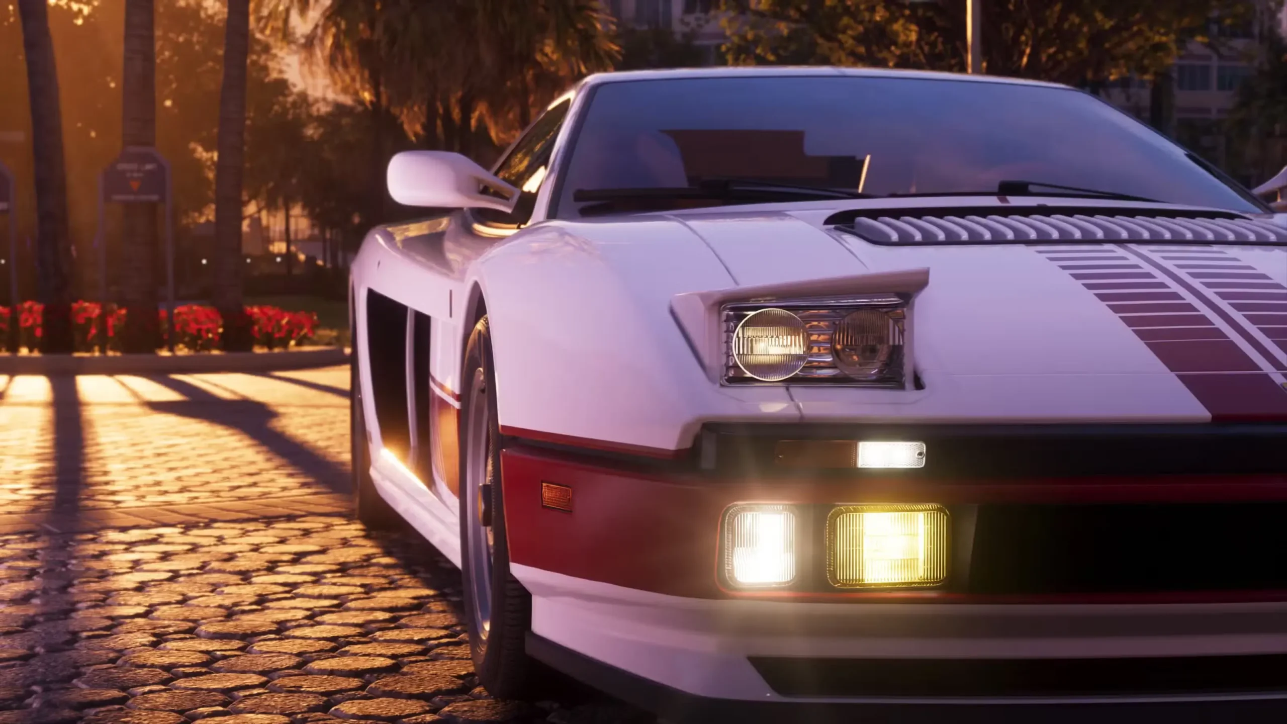 Balts retro stila sporta auto ar sarkanām svītrām saulrieta apspīdētā Vice City ielā spēlē GTA 6.